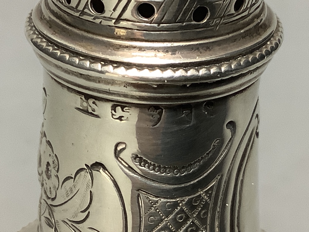 A George III silver baluster caster, with later embossed decoration, Thomas Shepherd, London, 1785, 15.5cm